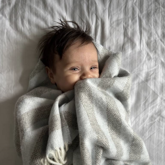 Beautiful baby gift set featuring a folded wool blanket and soft toy, perfect for new parents and thoughtful baby presents.