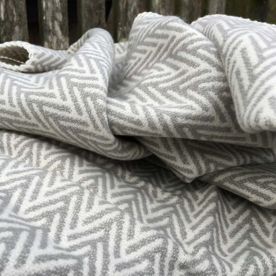 Super soft cotton throw in a contemporary grey and white herringbone pattern – part of the Cotton Blanket and Throw Collection.