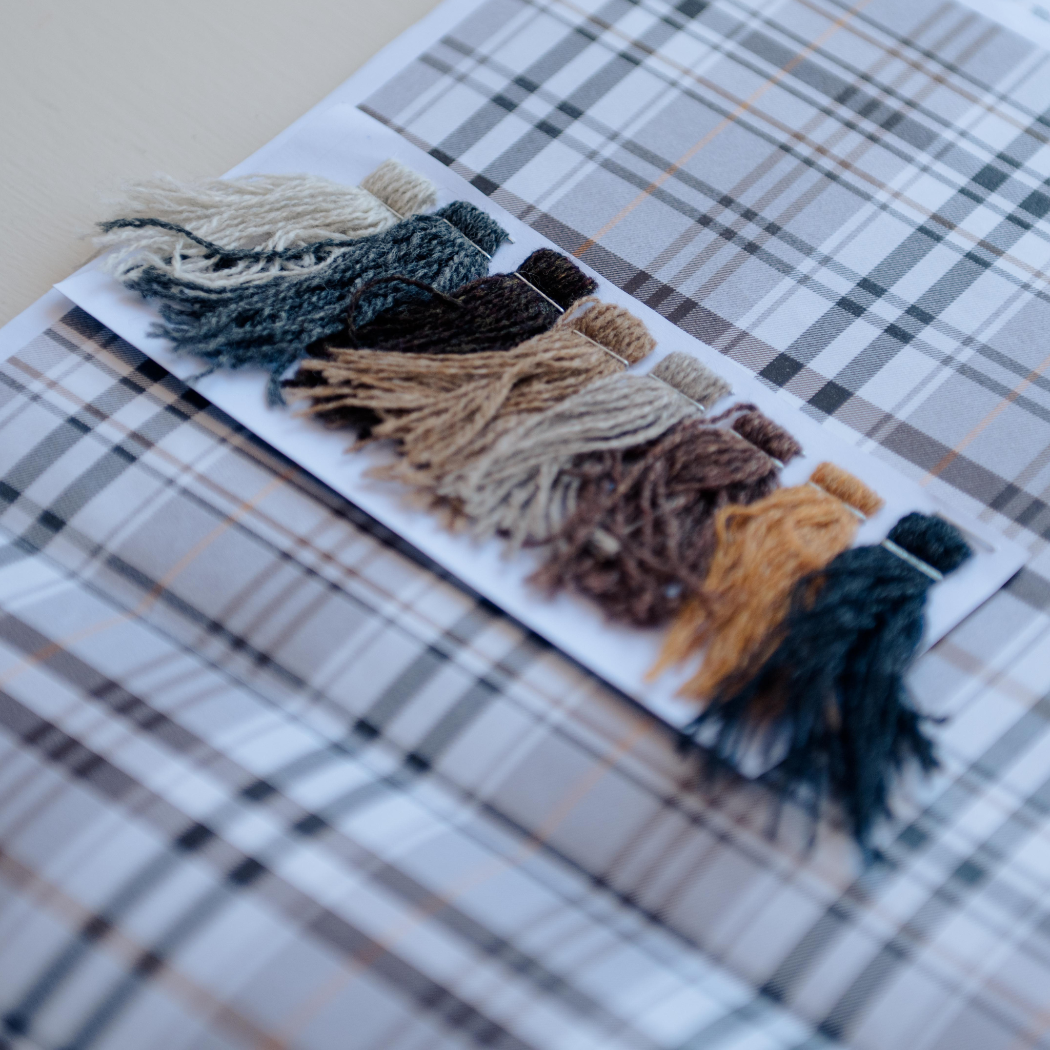 samples of coloured yarn, matching against a  companies brand colours along with CAD design sheet for a bespoke blanket design