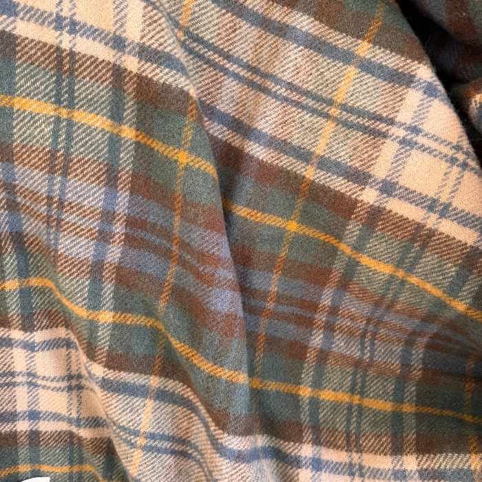 A close-up of Antique Dress Stewart blanket, draped to show full tartan pattern with green, blue, brown, yellow and off white tones