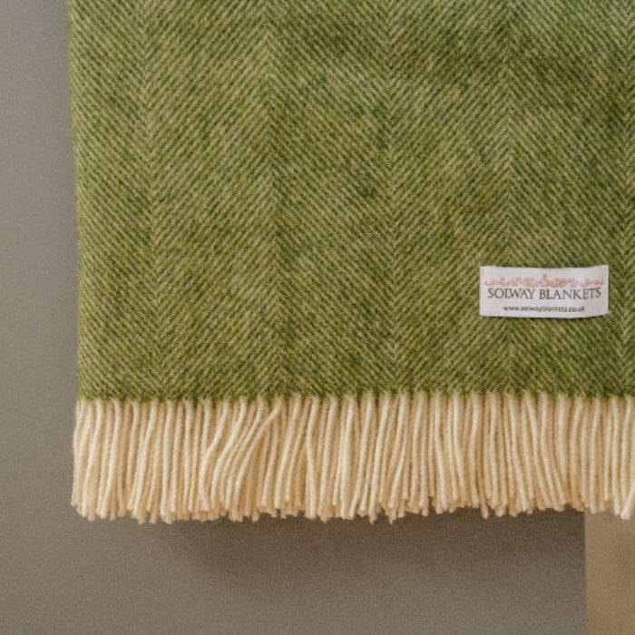 Apple Green Herringbone Shetland Wool Blanket with a visible Solway Blankets brand label on a neutral background