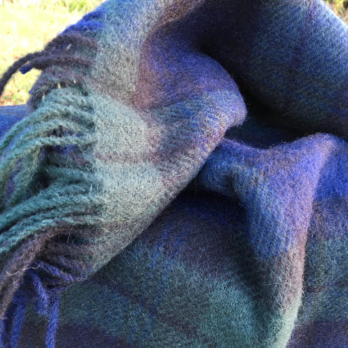Close up of a Black Watch tartan knee rug with fringes