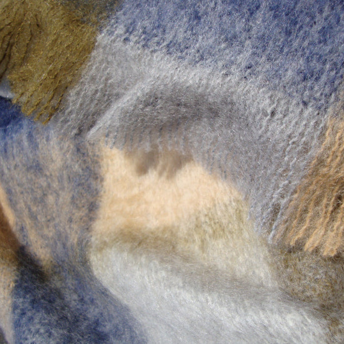 Close-up of textured Denim & Stone Mohair Throw with blue, beige, and brown colors