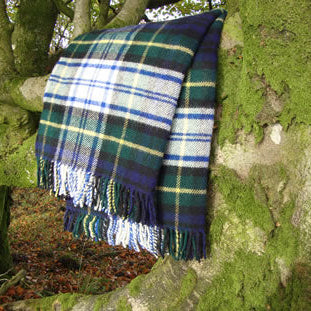 Dress Gordon Tartan Plaid  pure natural wool blanket draped over a tree branch in a forest setting