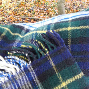 Dress Gordon Tartan Plaid blanket with blue, green and yellow colours on a natural background.