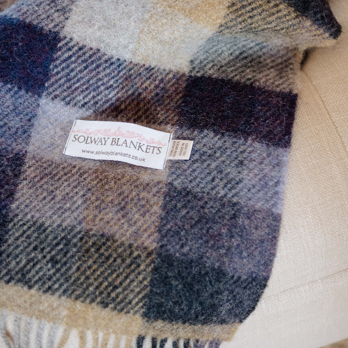 Lilac, grey and beige plaid wool blanket with a Solway Blankets label 