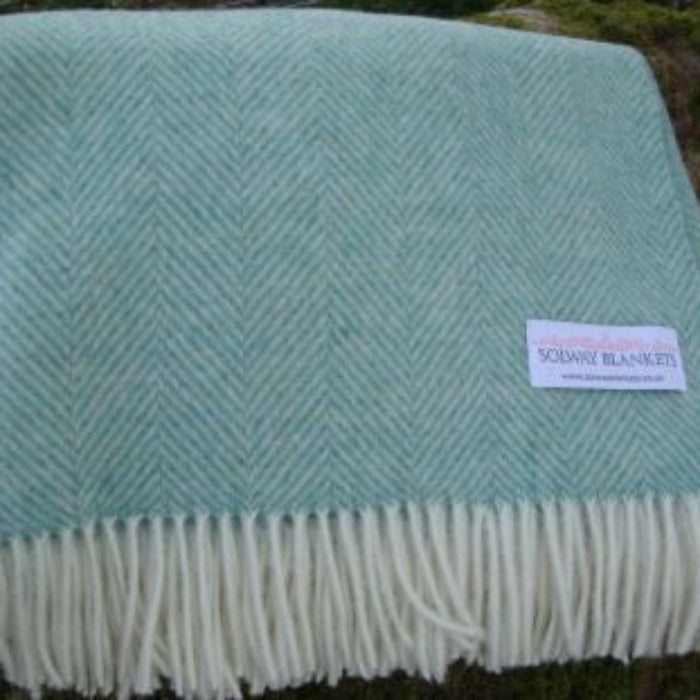 Eucalyptus herringbone patterned blanket throw with white fringe featuring a Solway Blankets label on a natural background