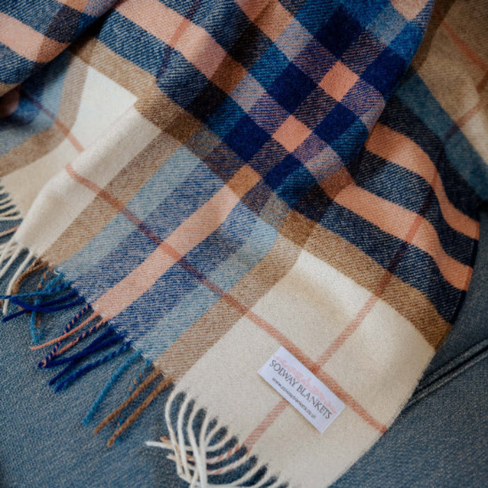 Falmouth Blue & Ivory Check Shetland Wool Blanket with fringes and a visible Solway Blankets brand label on a textured surface