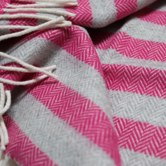 Georgina Stripe Cashmere Mix Baby Blanket a striped blanket with tassels on a surface
