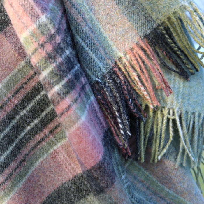 Green Kintyre Check Shetland Wool Throw blanket with fringes in a soft colour palette of green and pink plaid background