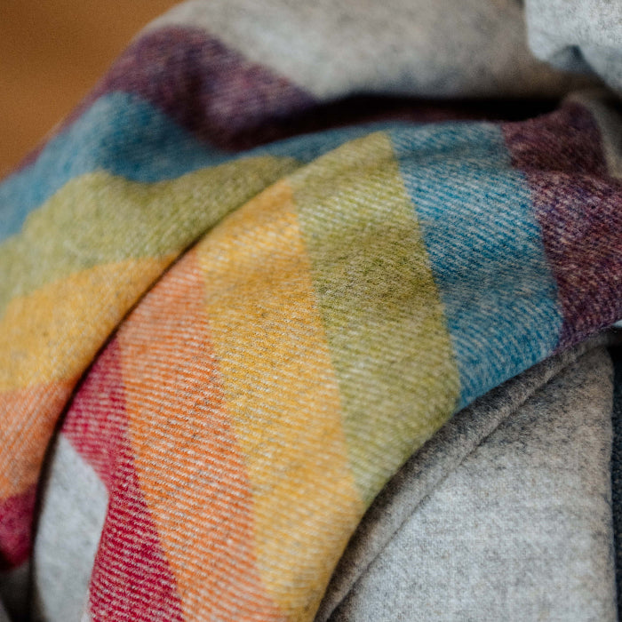Close-up of colourful Highland Horizon Shetland Wool Rainbow Stripe Blanket showing wool texture