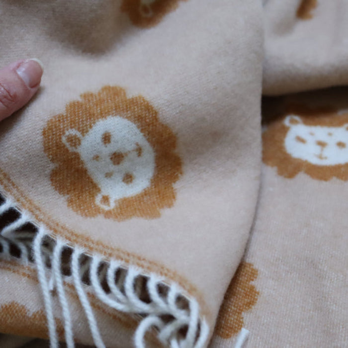 Lion Caramel Merino Wool Baby Blanket with white fringe and hand feeling softness