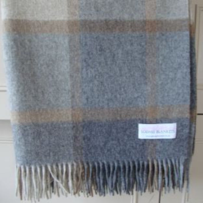 Natural plaid blanket with a Solway Blankets label on a neutral background