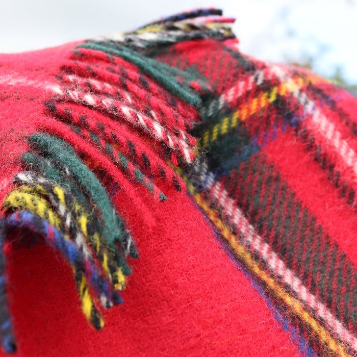 Close up of a Royal Stewart Tartan knee rug with fringe, outdoors