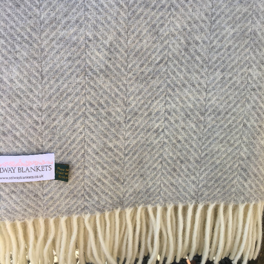 Silver grey and creamy white herringbone wool blanket with a visible Solway Blankets label.
