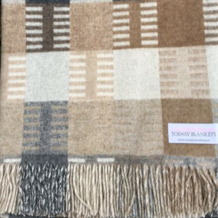 Folded plaid natural blanket with fringes and a visible Solway Blankets label 